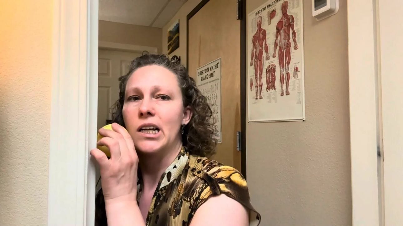 Positioning the ball on the masseter muscle using the doorway for support