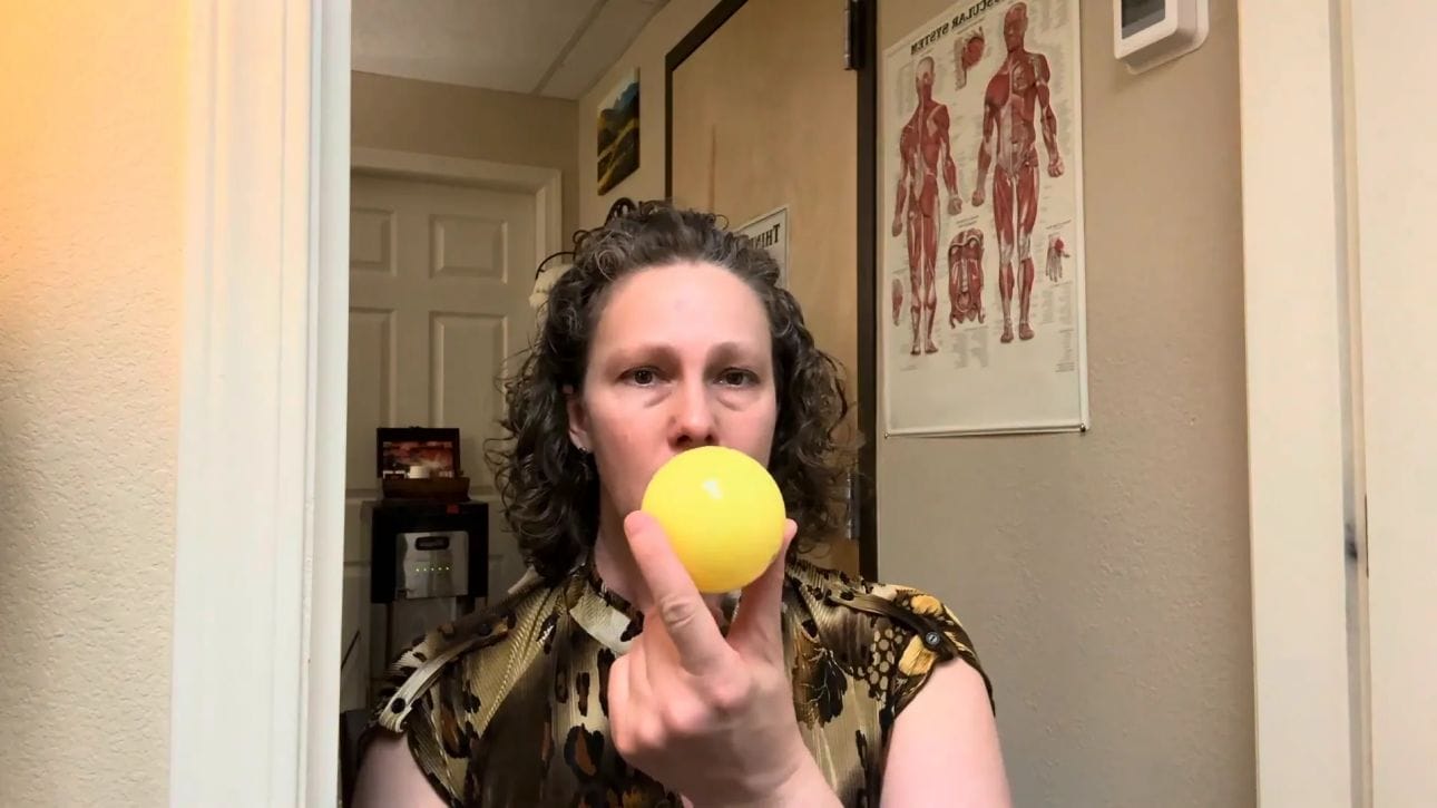 Using a soft ball for masseter self massage against a doorway