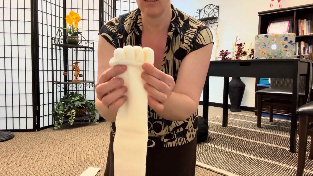 Putting on toe separator sock