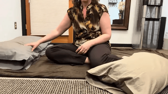 Two stacked pillows and a small pillow for arm support