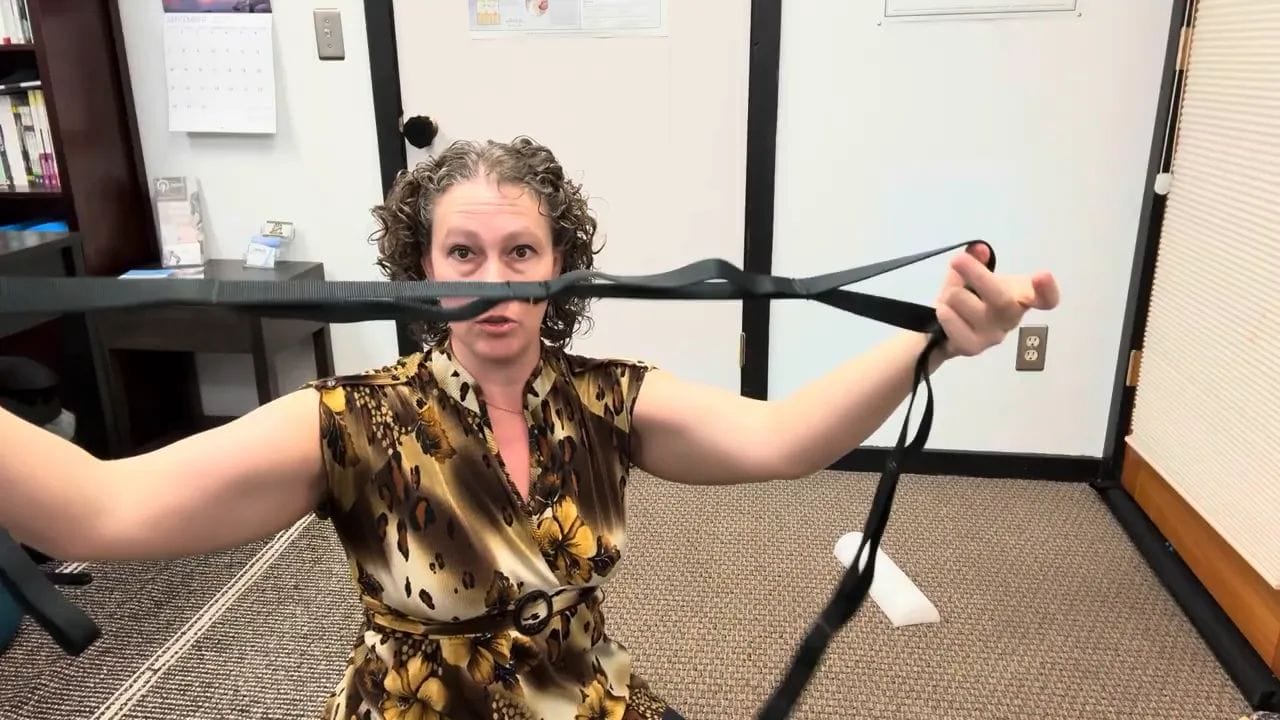 Emily holding the strap with foot and hand loops